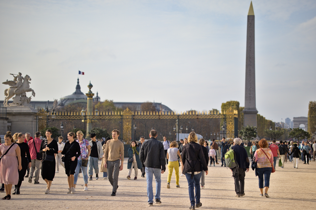 A crowd walking to and from the Luxor Obelisk Paris, France.